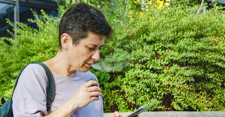 short haired woman vaping considerately