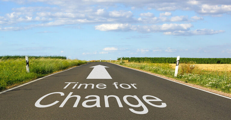 Road with 'Time for Change' sign