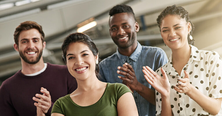 Group of people applauding together.