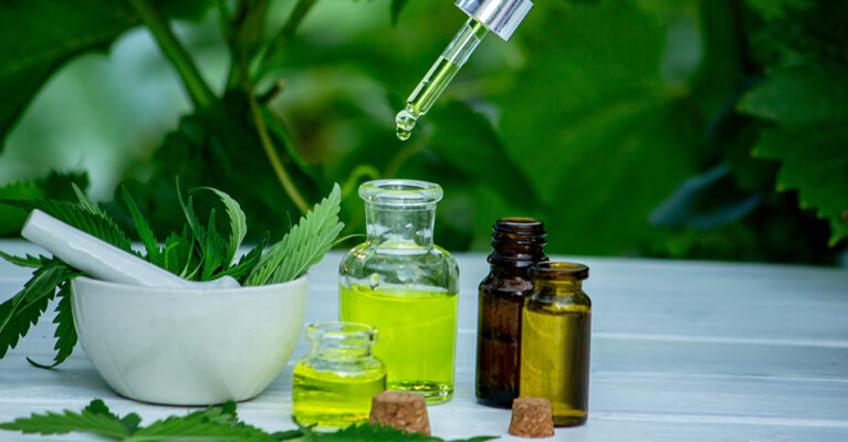 Herbal oils and fresh green leaves