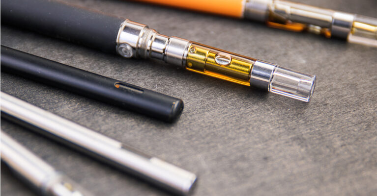 Various vape pens on a surface