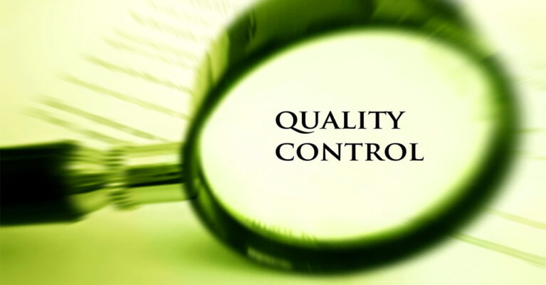 Magnifying glass over quality control text