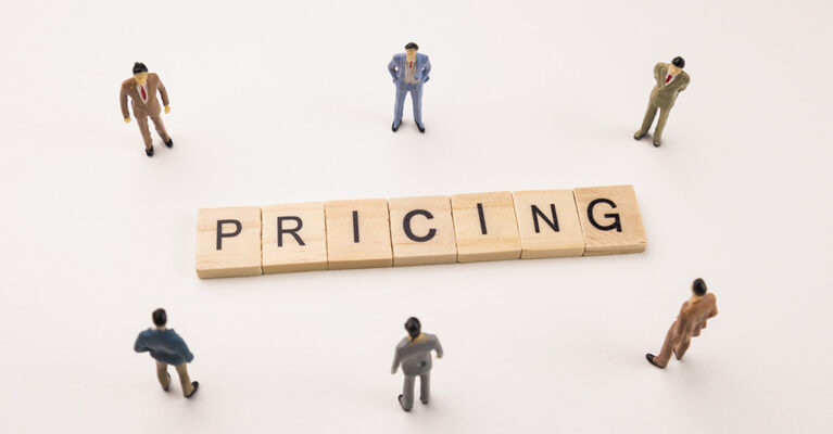 Miniature figures around pricing letters