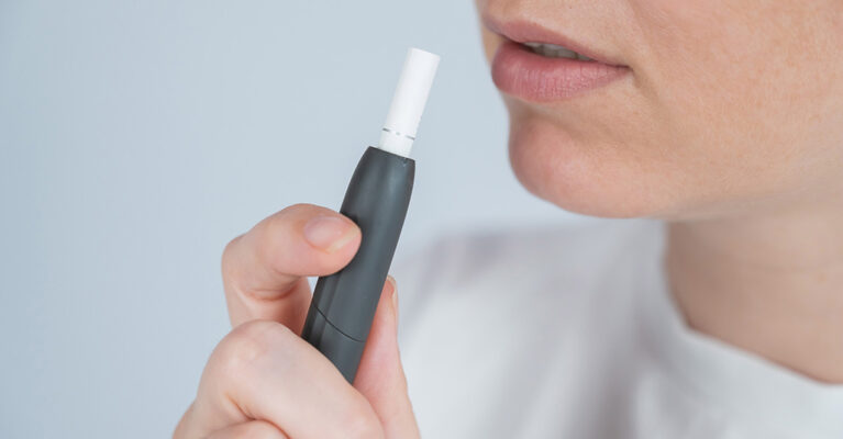 Person holding a smoking device.