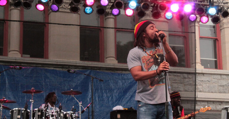 Musician performing on stage with band