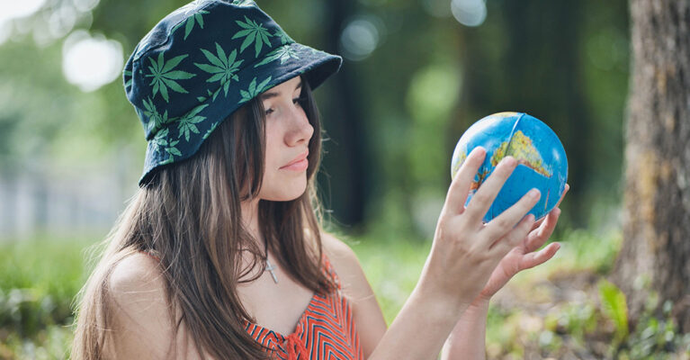 Woman holding and looking at a model of the world
